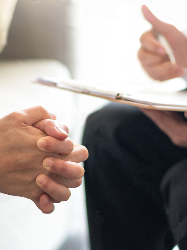 image of clasped hands and and another person holding a notepad and pen